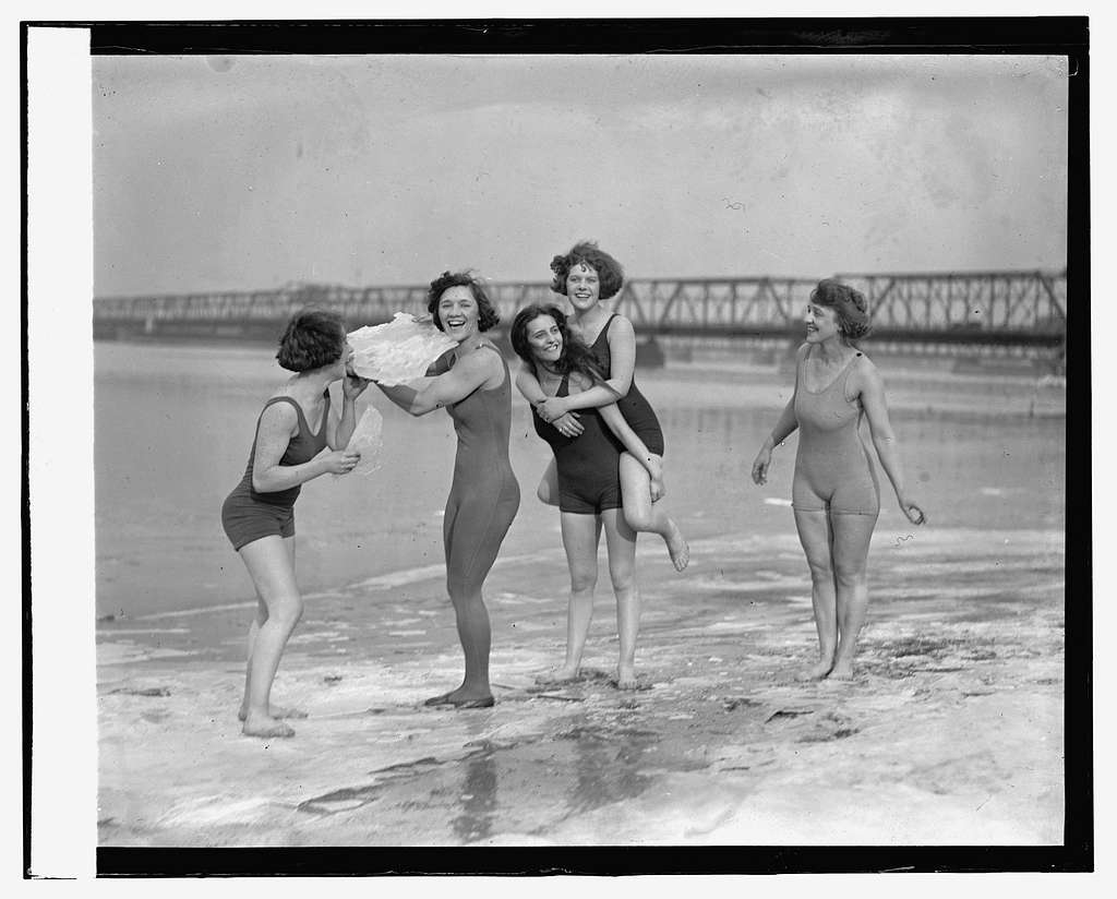 Five white women on a beach in a black and white photograph, mid-20 c. 