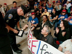 Rabbi Lew and others facing down a police officer a protest