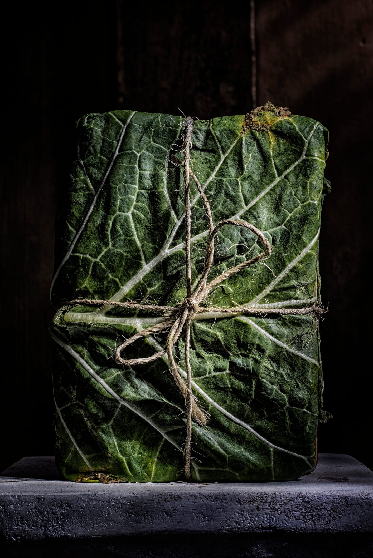 book wrapped in leaf tied with twine 